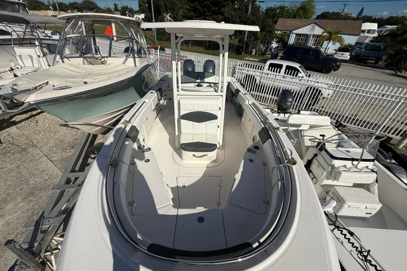 Slide: The Image of 2019 Robalo R242 Center Console boat with spacious deck and seating, docked outdoors. - 3
