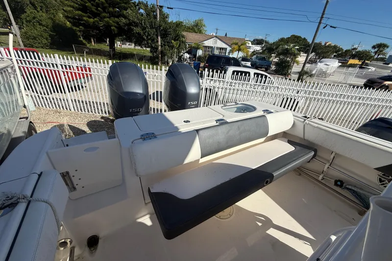 Slide: The Image of 2019 Robalo R242 Center Console boat with dual 150 horsepower engines, docked outdoors. - 7