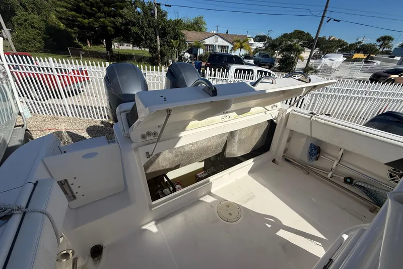 Slide: The Image of 2019 Robalo R242 Center Console boat with open storage compartment and dual engines. - 8