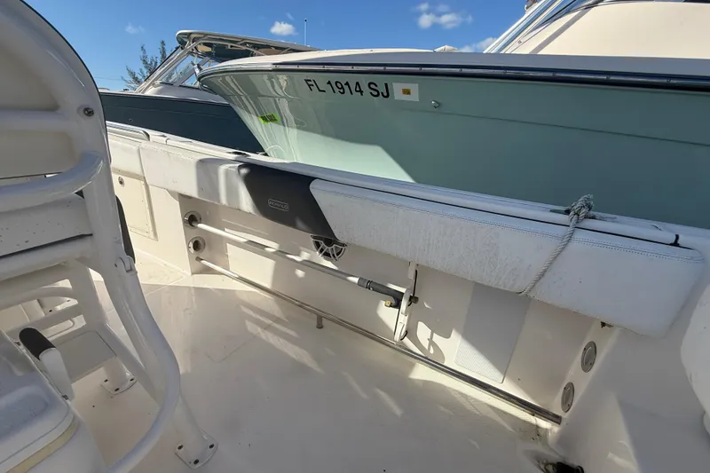 Slide: The Image of 2019 Robalo R242 Center Console boat interior with seating and storage. - 9