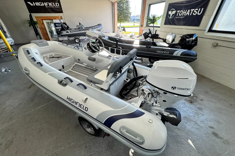 The Image of 2026 Highfield Classic 360 FCT boat with Tohatsu engine in showroom. - 1