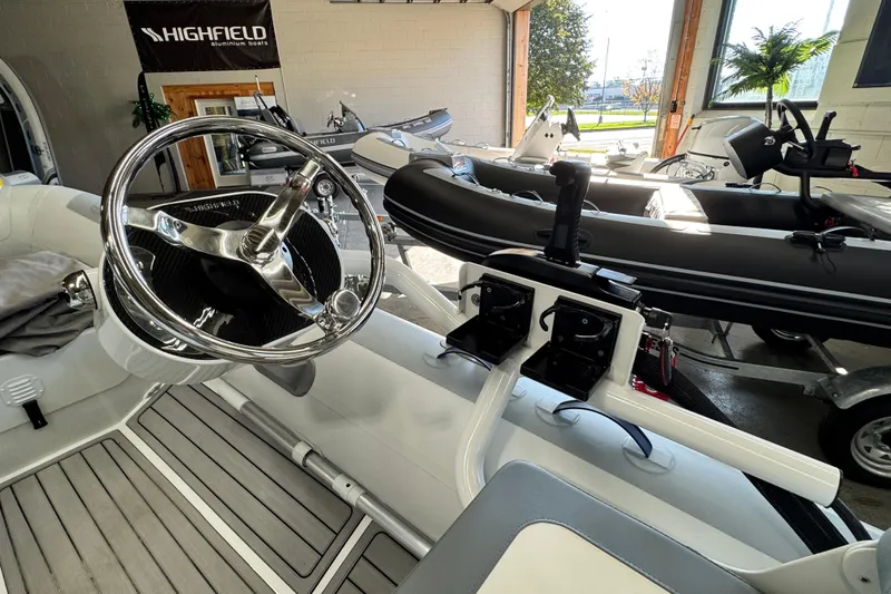 Slide: The Image of 2026 Highfield Classic 360 FCT boat interior with steering wheel and controls. - 10