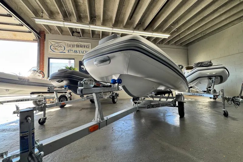 Slide: The Image of 2026 Highfield Classic 360 FCT boat on trailer in showroom. - 12