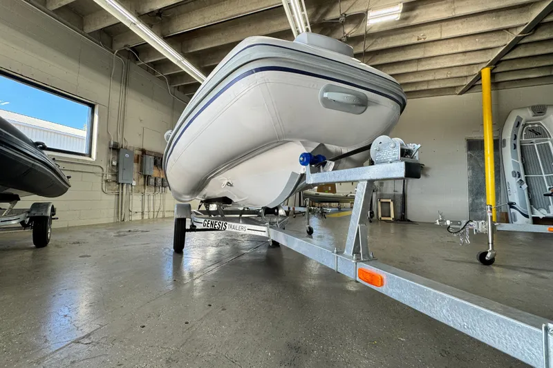Slide: The Image of 2026 Highfield Classic 360 FCT boat on Genesis trailer in a garage. - 13
