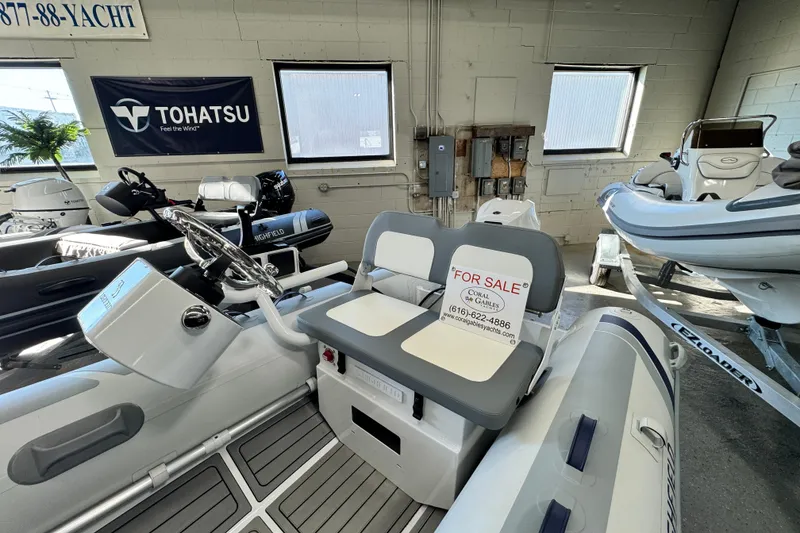 Slide: The Image of 2026 Highfield Classic 360 FCT boat for sale in showroom, featuring Tohatsu engine. - 4