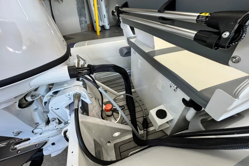 Slide: The Image of 2026 Highfield Classic 360 FCT boat interior, showcasing engine components and seating area. - 6