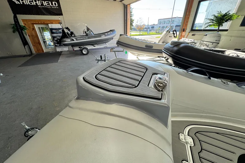 Slide: The Image of 2026 Highfield Classic 360 FCT boat displayed in a showroom with other models. - 8