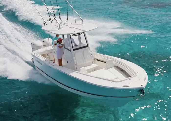 Slide: The Image of 2026 Regulator 25 boat with Yamaha engine, docked under cloudy skies. - 1