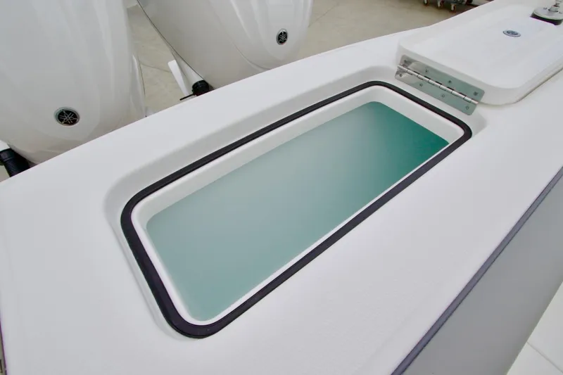 Slide: The Image of 2026 Regulator 25 boat with open storage compartment and visible outboard engines. - 10