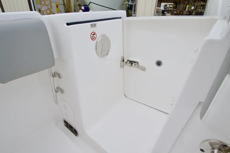 Slide: The Image of 2026 Regulator 25 boat interior, featuring a white compartment with a secure latch. - 11