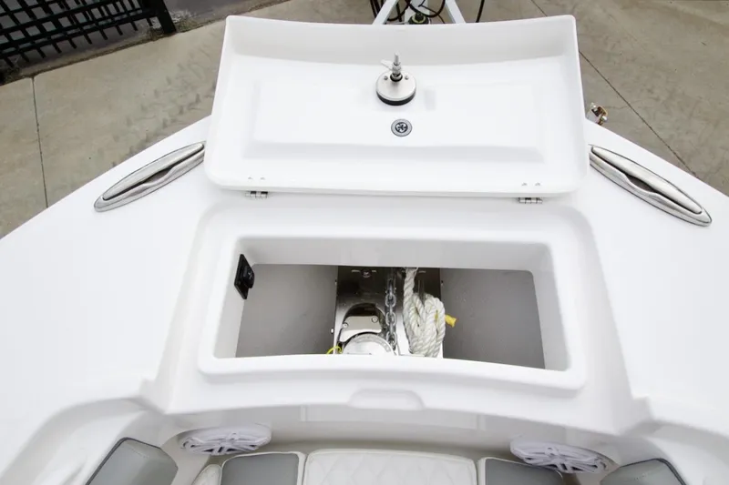 Slide: The Image of 2026 Regulator 25 boat anchor storage compartment with open lid, showcasing chain and rope. - 14