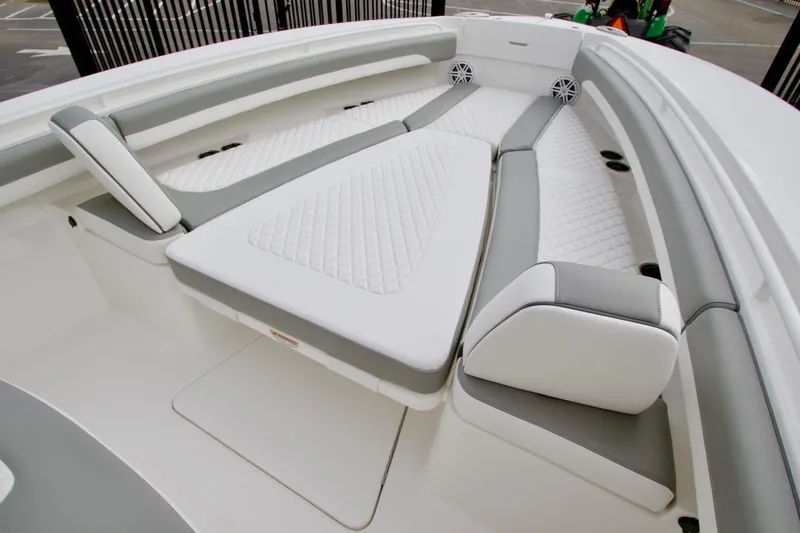 Slide: The Image of Luxurious seating area on 2026 Regulator 25 boat with white and gray upholstery. - 15