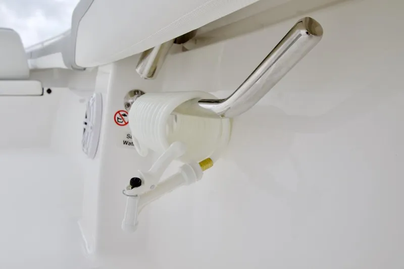 Slide: The Image of 2026 Regulator 25 boat detail with stainless steel rod holder and coiled hose. - 16