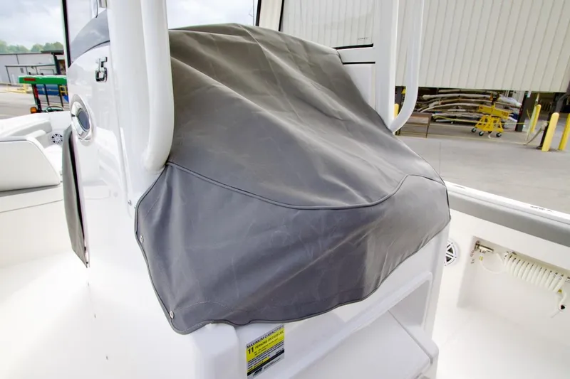 Slide: The Image of 2026 Regulator 25 boat console covered with a protective gray tarp. - 19