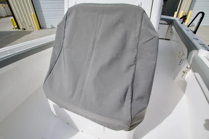 Slide: The Image of Covered seat on 2026 Regulator 25 boat, docked in a marina. - 20