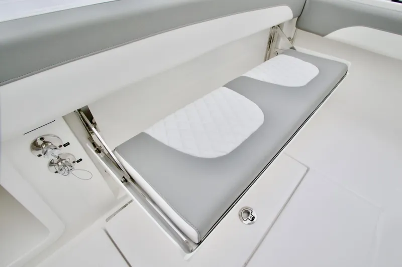 Slide: The Image of 2026 Regulator 25 boat interior with gray and white cushioned seating. - 9