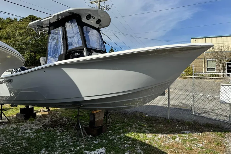 The Image of 2025 Sea Pro 222 Center Console boat on display, elevated on stands outdoors. - 0