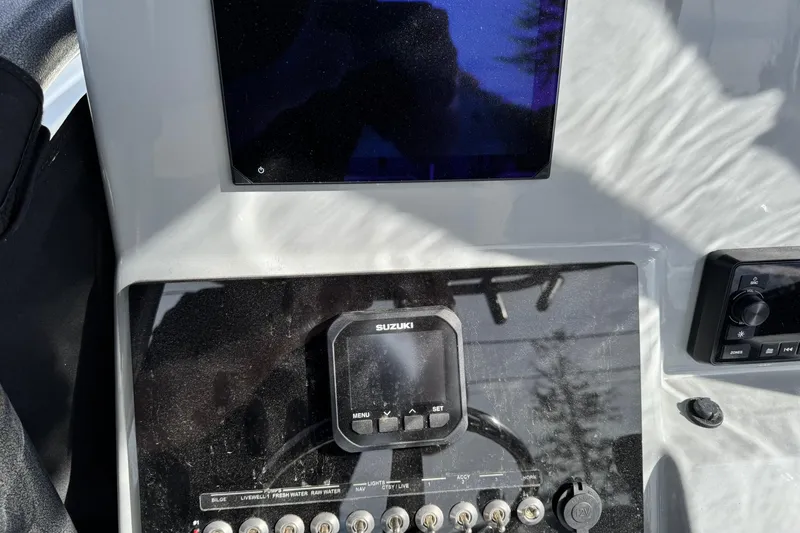 Slide: The Image of 2025 Sea Pro 222 Center Console boat with modern helm and seating, docked outdoors. - 10