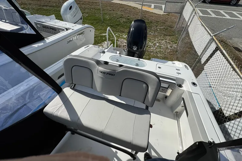 Slide: The Image of 2025 Sea Pro 222 Center Console boat dashboard with steering wheel and controls. - 13