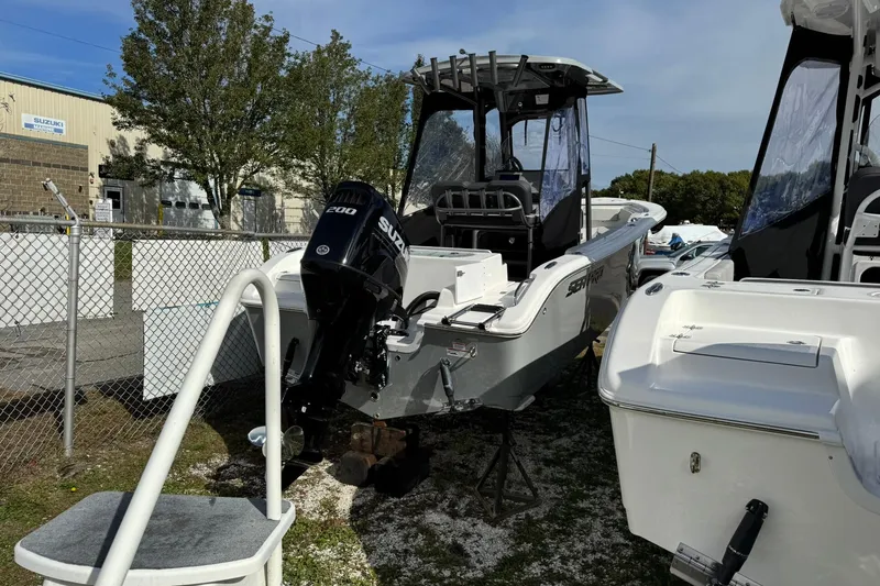 Slide: The Image of 2025 Sea Pro 222 Center Console boat with 200 HP engine, docked outdoors. - 6
