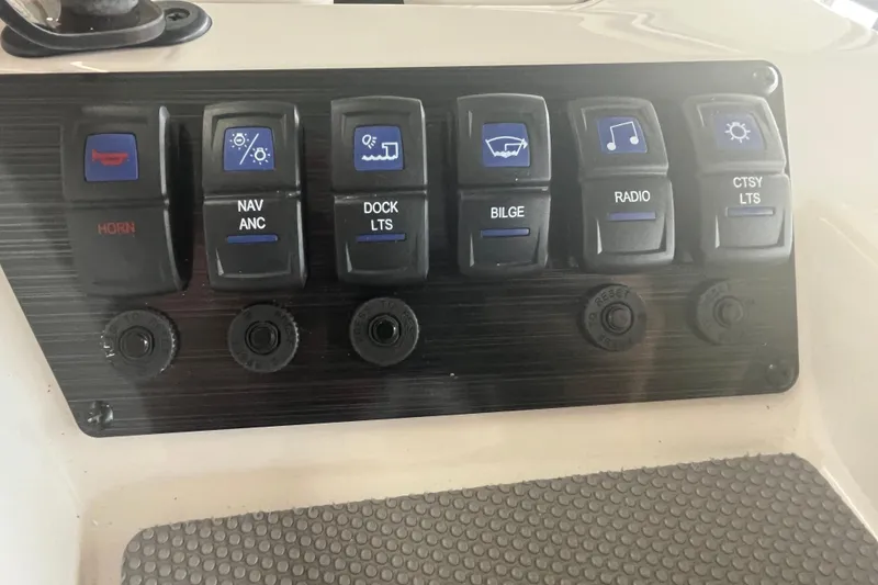 Slide: The Image of Control panel of 2026 Starcraft SV 16 OB boat with labeled switches. - 19