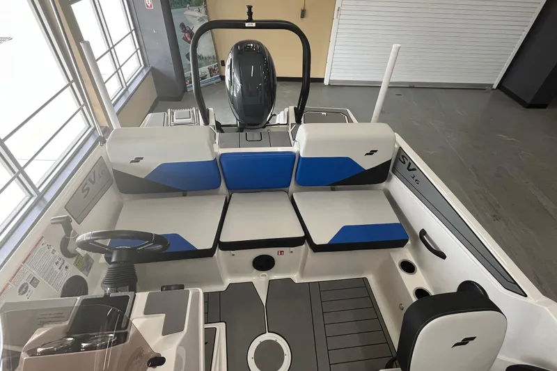 Slide: The Image of 2026 Starcraft SV 16 OB boat interior with blue and white seating, steering wheel, and motor. - 21
