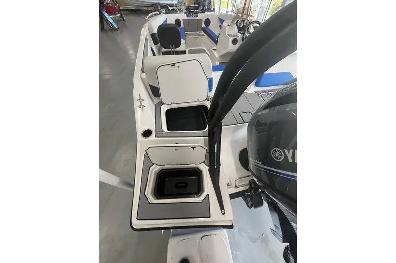 Slide: The Image of 2026 Starcraft SV 16 OB boat interior with open storage compartments and Yamaha engine. - 23