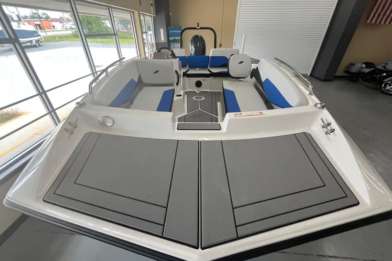 Slide: The Image of 2026 Starcraft SV 16 OB boat interior with blue and gray seating in showroom. - 25
