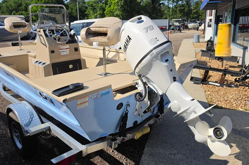 Slide: The Image of 2026 G3 Bay 17 boat cruising on water with a person steering. - 16
