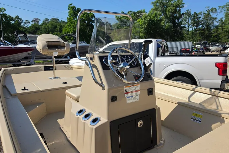 Slide: The Image of Man navigating G3 Bay 17 boat on a serene lake, 2026 model. - 17