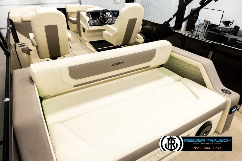 Slide: The Image of Interior of 2026 Alera M23L boat with beige seating and modern dashboard. - 11