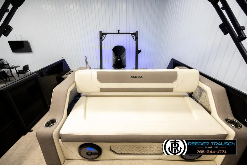 Slide: The Image of 2026 Alera M23L boat interior with cushioned seating in a showroom. - 15