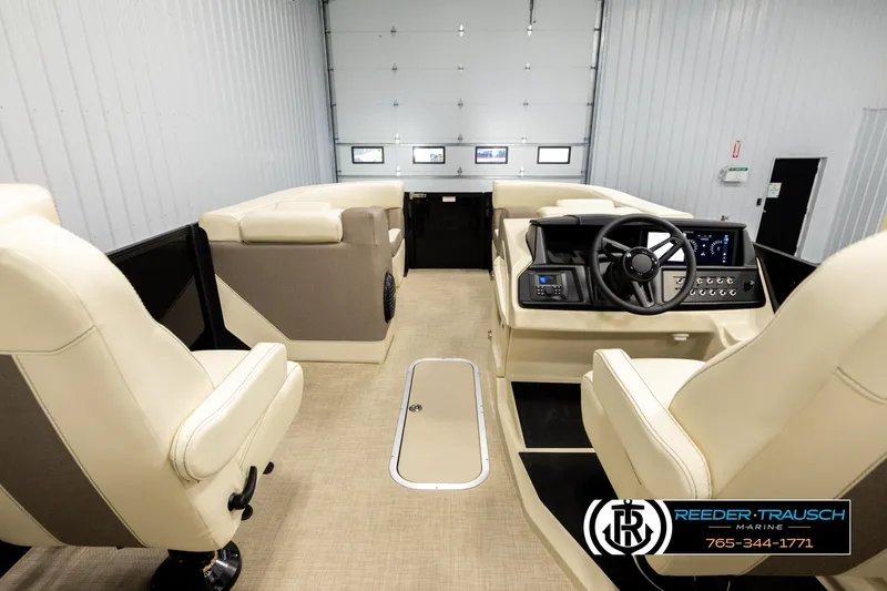 Slide: The Image of Interior of 2026 Alera M23L boat with modern steering and beige seating. - 17