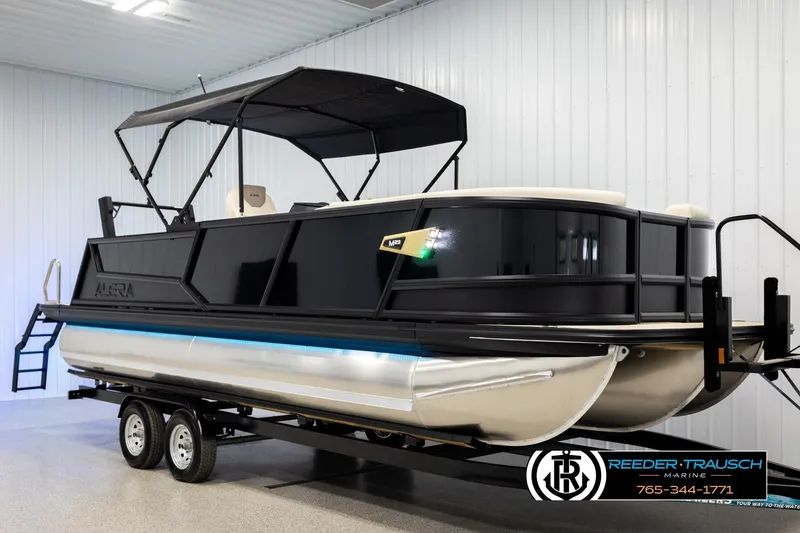 Slide: The Image of 2026 Alera M23L pontoon boat on trailer in indoor showroom. - 3