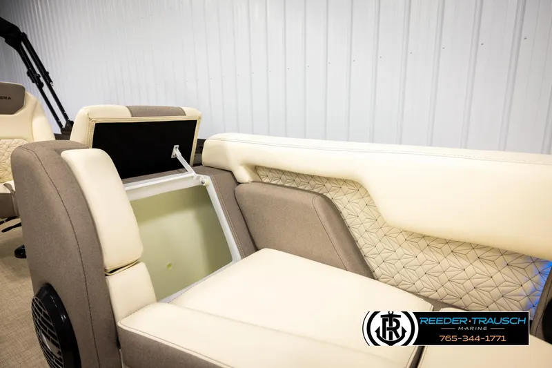 Slide: The Image of Alera M23L 2026 boat interior with beige and cream seating, storage compartment open. - 31