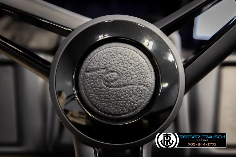 Slide: The Image of Steering wheel of 2026 Alera M23L boat, featuring sleek black design. - 34