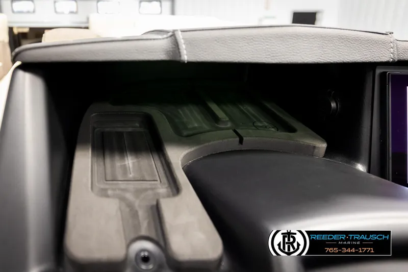 Slide: The Image of Interior dashboard of 2026 Alera M23L boat, featuring storage compartment. - 36