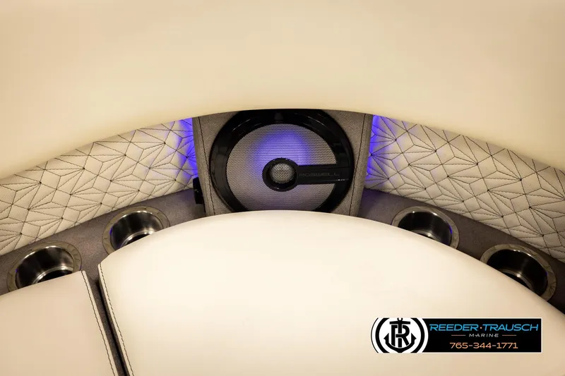 Slide: The Image of Interior of 2026 Alera M23L boat with speaker, cup holders, and patterned upholstery. - 43
