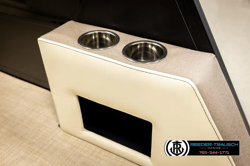 Slide: The Image of Alera M23L 2026 boat interior with dual cup holders and beige upholstery. - 48