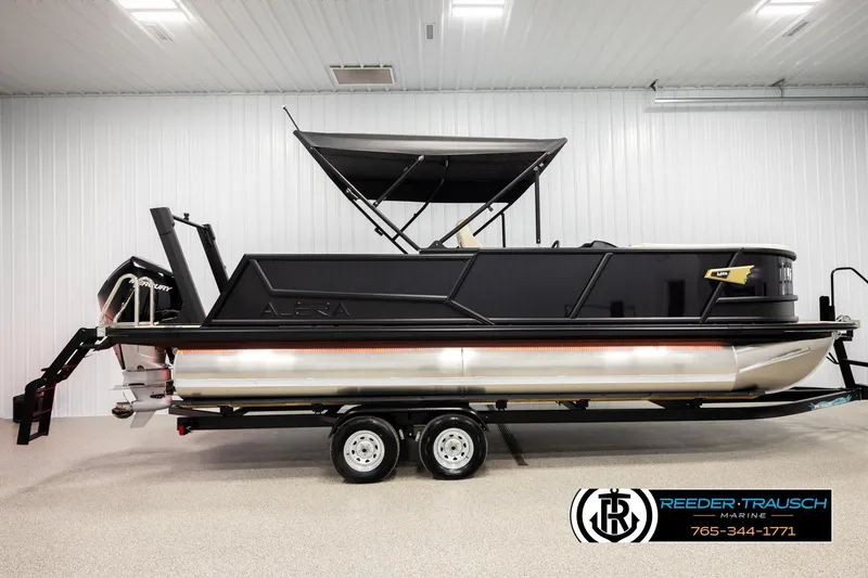 Slide: The Image of 2026 Alera M23L pontoon boat in showroom, featuring sleek black design and modern amenities. - 5