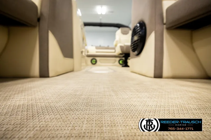 Slide: The Image of Interior view of 2026 Alera M23L boat with beige flooring and seating. - 52