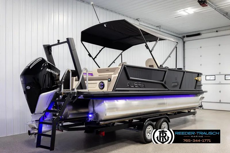 Slide: The Image of 2026 Alera M23L pontoon boat with Mercury engine in indoor showroom. - 6