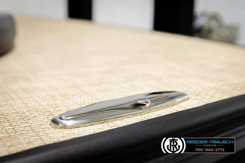 Slide: The Image of Alera M23L 2026 boat deck with sleek chrome cleat, Reeder-Trausch Marine branding. - 61