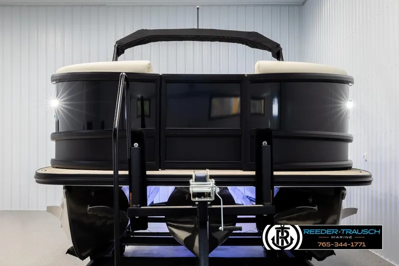 Slide: The Image of 2026 Alera M23L pontoon boat in showroom, front view with trailer. - 8