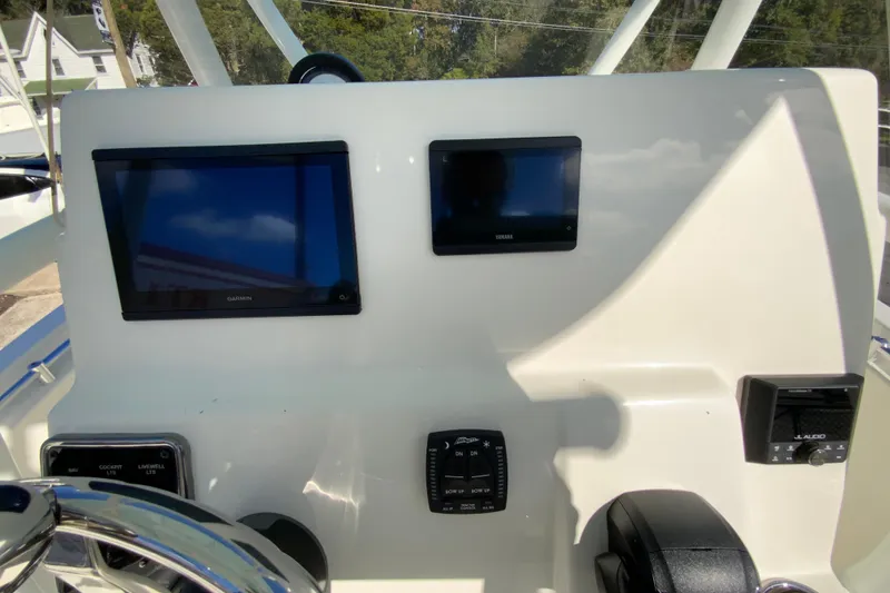 Slide: The Image of 2026 Cobia 220 Center Console dashboard with Garmin and Yamaha displays. - 12
