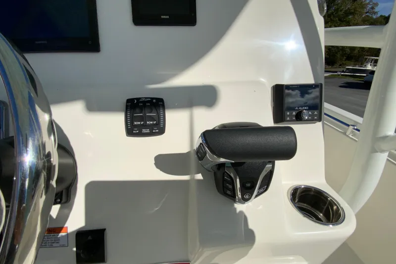 Slide: The Image of 2026 Cobia 220 Center Console boat dashboard with controls and audio system. - 13
