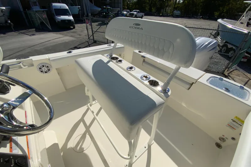 Slide: The Image of 2026 Cobia 220 Center Console boat interior with seating and steering wheel. - 14
