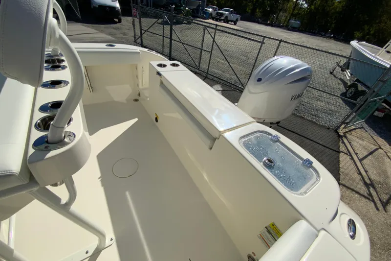 Slide: The Image of 2026 Cobia 220 Center Console boat interior with Yamaha outboard motor. - 16