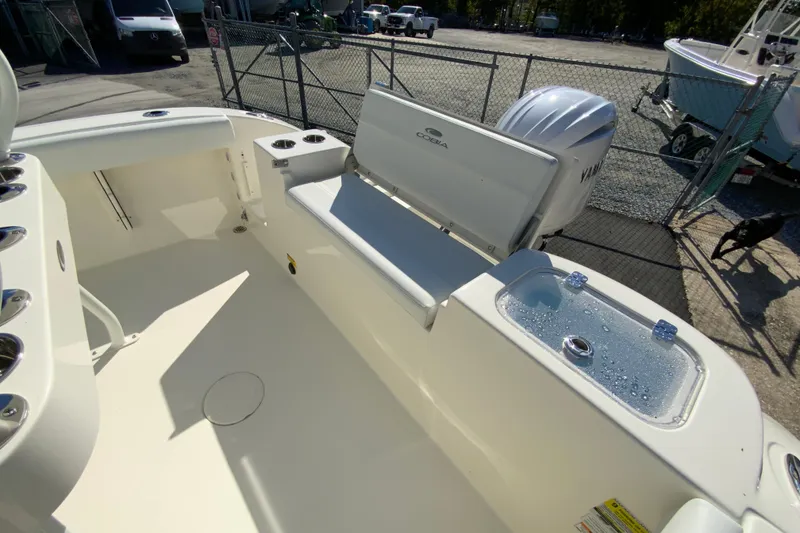 Slide: The Image of 2026 Cobia 220 Center Console boat interior with Yamaha engine, featuring seating and livewell. - 17