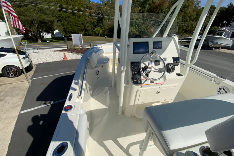 Slide: The Image of 2026 Cobia 220 Center Console boat interior with steering wheel and control panel. - 18